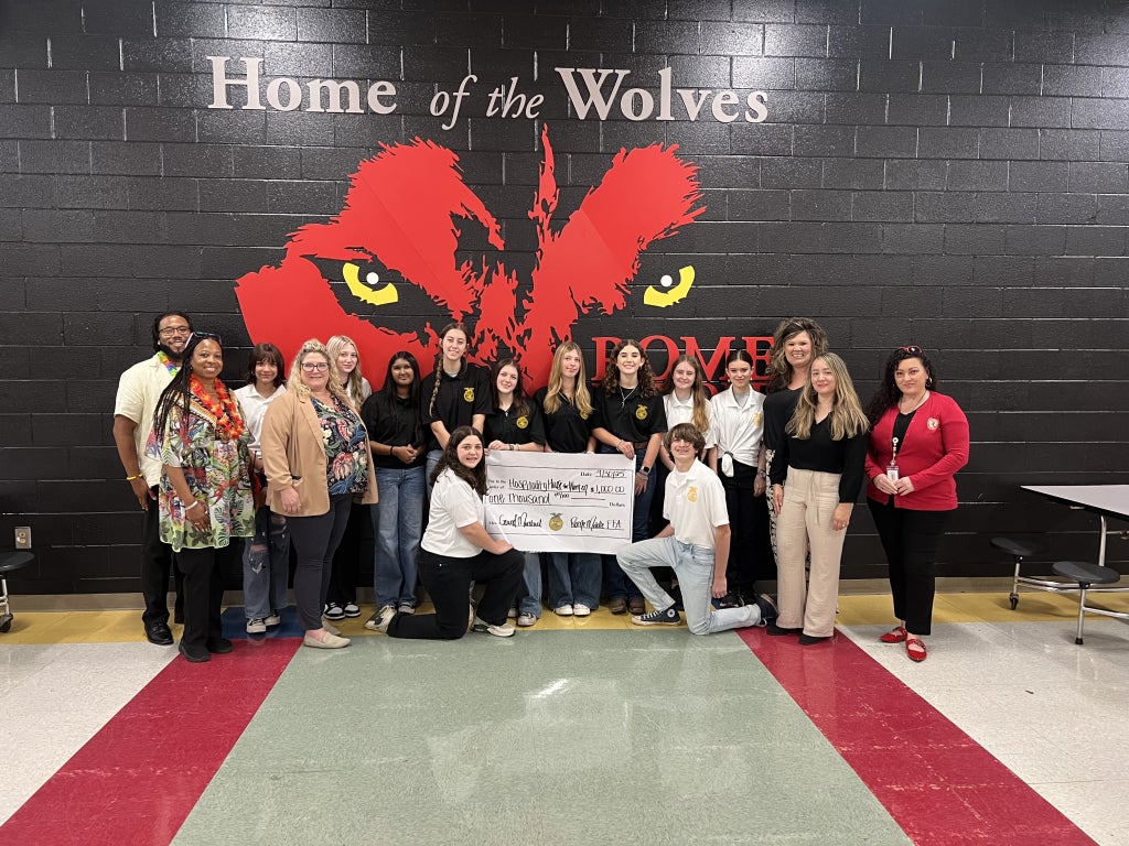 FFA Members and leaders take a photo presenting a donation to the Women's Hospitality House.