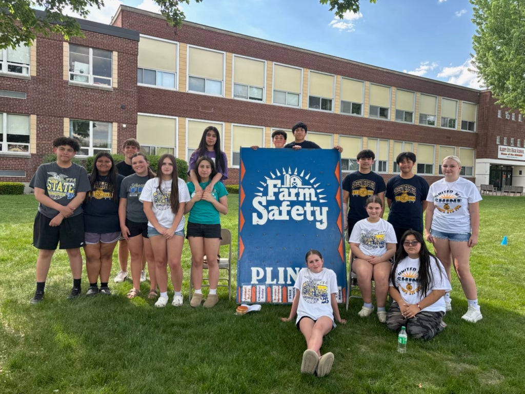 Sleepy Eye FFA members stand in front of the Farm Safety Plinko game