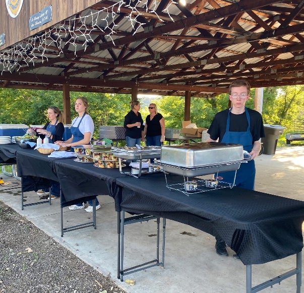 Justus Marshall and other helpers serving for the Fondue for Youth coordinated by Main.