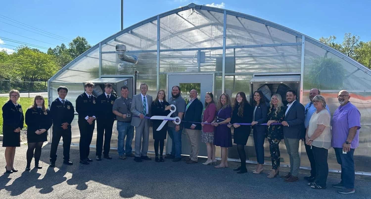 Amanda Mainord (5th from right) joins in at the ribbon cutting ceremony for the new Monterey FFA greenhouse.