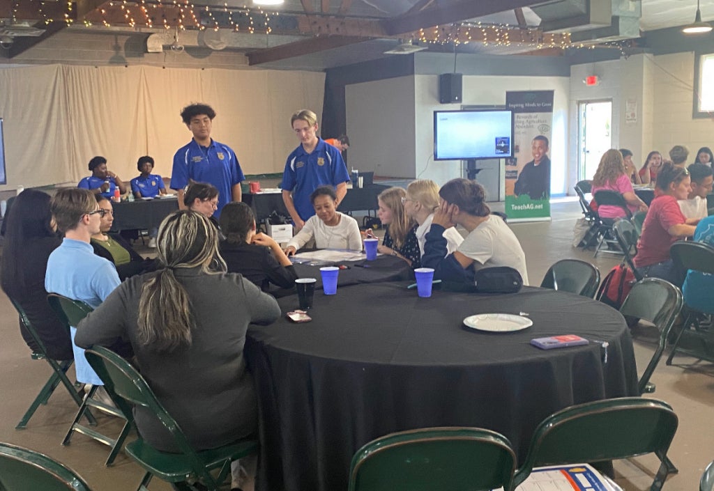Ernest Ilarde, Illinois FFA Section 8 treasurer and Colin King, Illinois FFA Section 8 vice president assisting the local chapter.