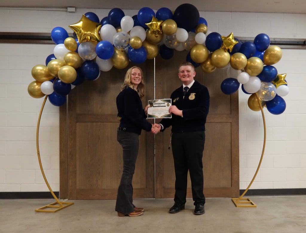 Hadley Hancock receiving her Greenhand degree from James Little.