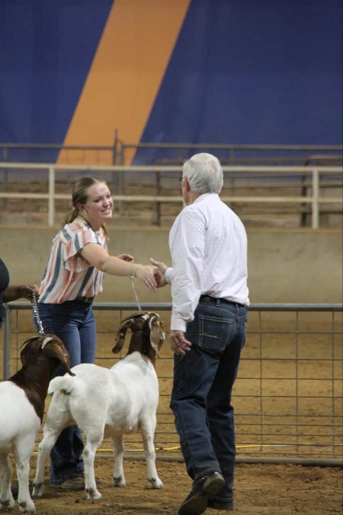 At the West Tennessee Junior Livestock Expo Goat Show held at the University of Tennessee, Lilly Campbell celebrates her victory of achieving Level 1 Showmanship in breeding does.