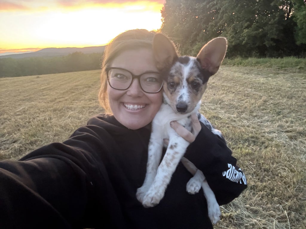 Hemond takes a selfie with her puppy, Bingo, in the hay field.