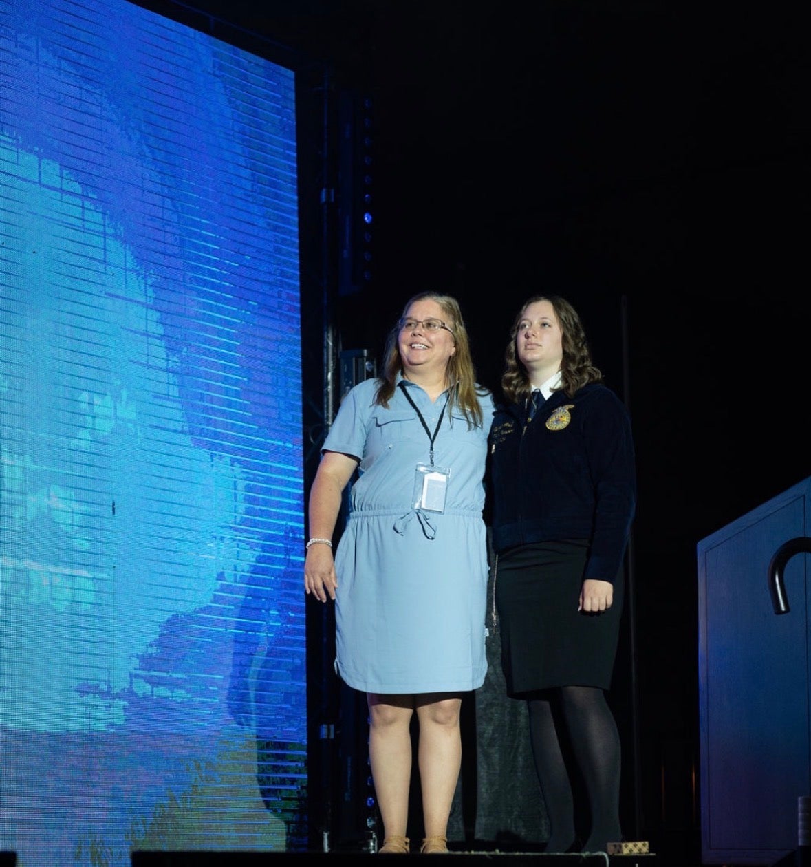 Lana Myers is on the stage at the Louisiana FFA State Convention and Expo, with one of her past state officers.