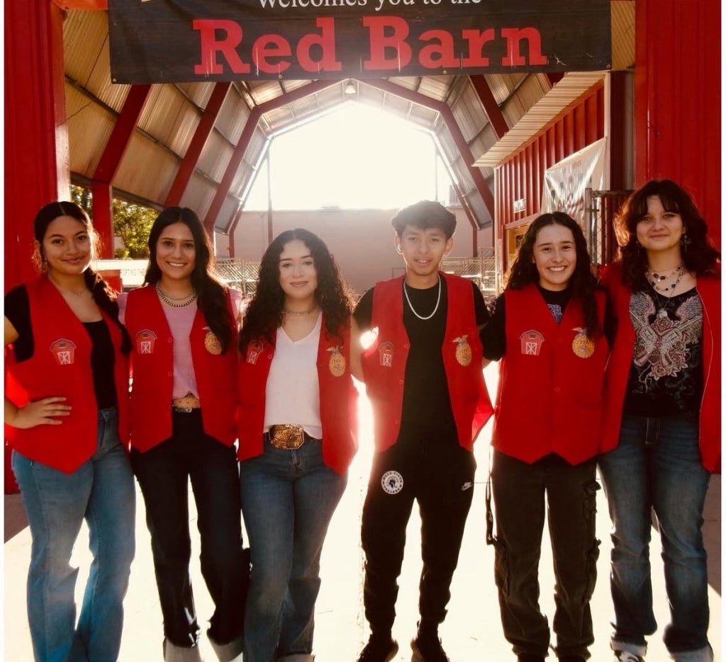 Destiny Jaramillo (third from left) stands with her FFA chapter in front of the Red Barn.