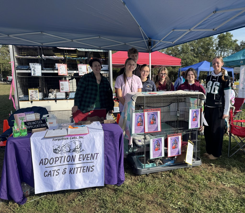 Members of the Appoquinimink FFA Chapter with a Forgotten Cats staff member during the event, featuring a litter of kittens for adoption.