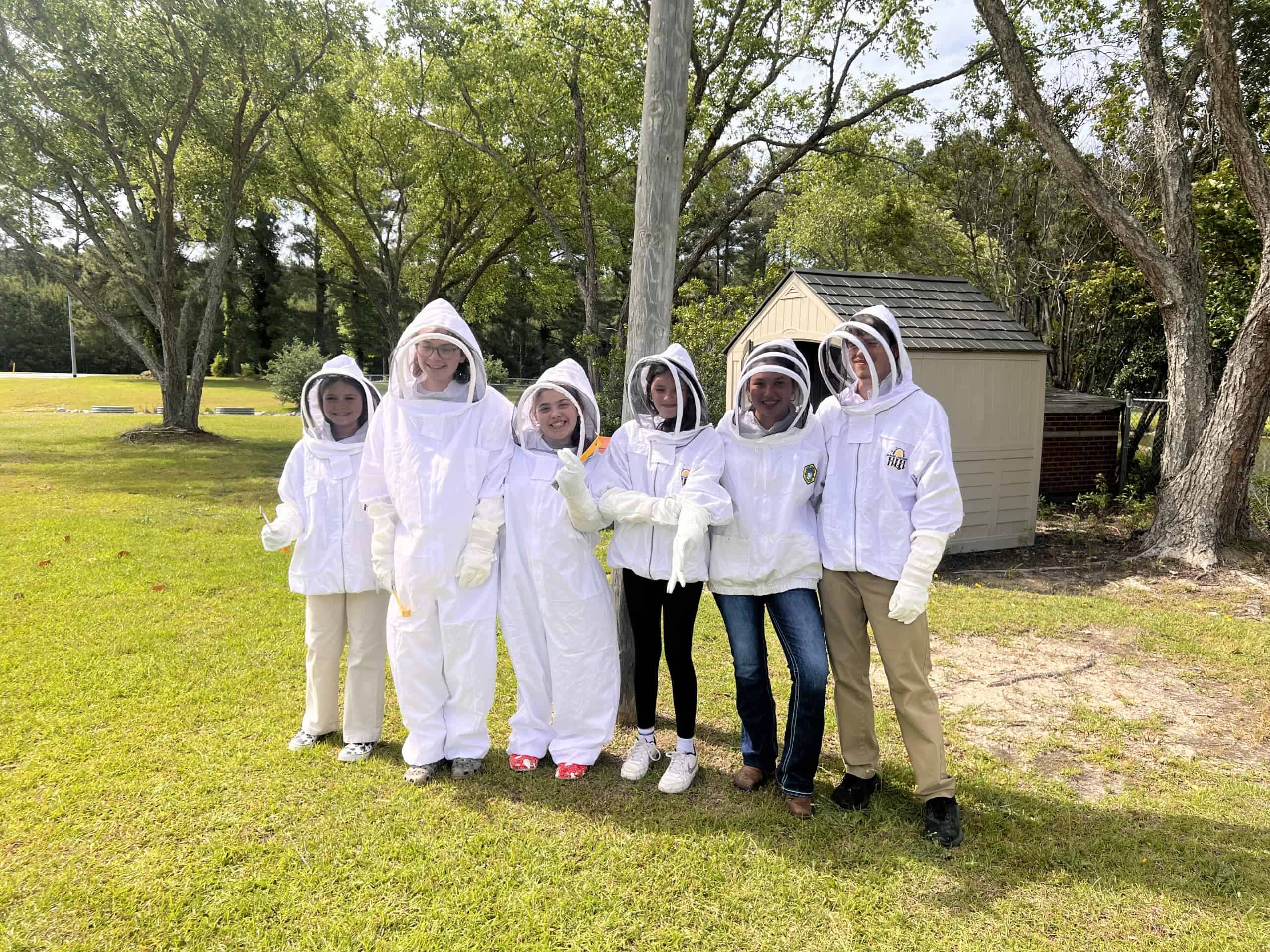 Various NECP FFA Beekeeping members join for a picture wearing Beehive Protective gear.