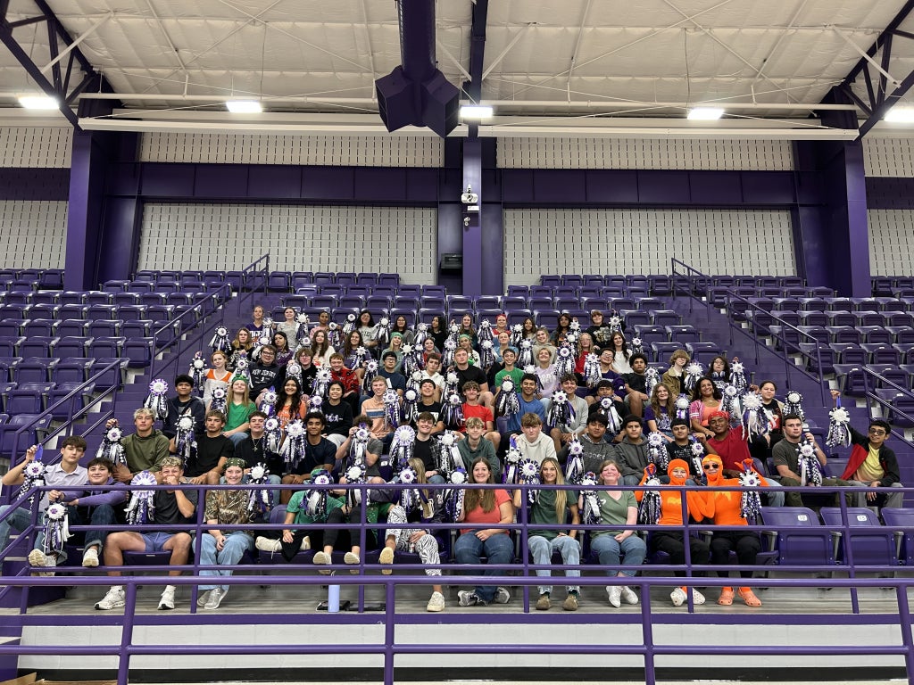 Jacksboro floral design students display the mums they made in class.