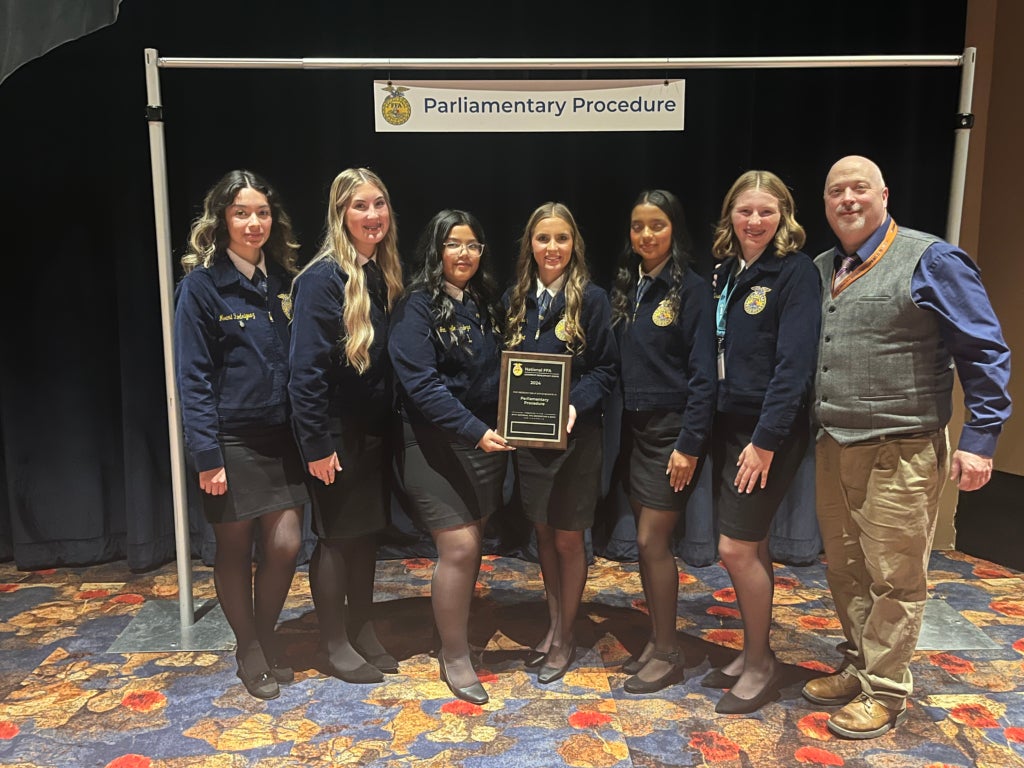McKay (far right) has coached teams to state and national parliamentary procedure championships, among other competitions.
