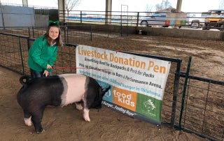 Maggie Carroll at eight years old donating her pig to Pork for Packs.