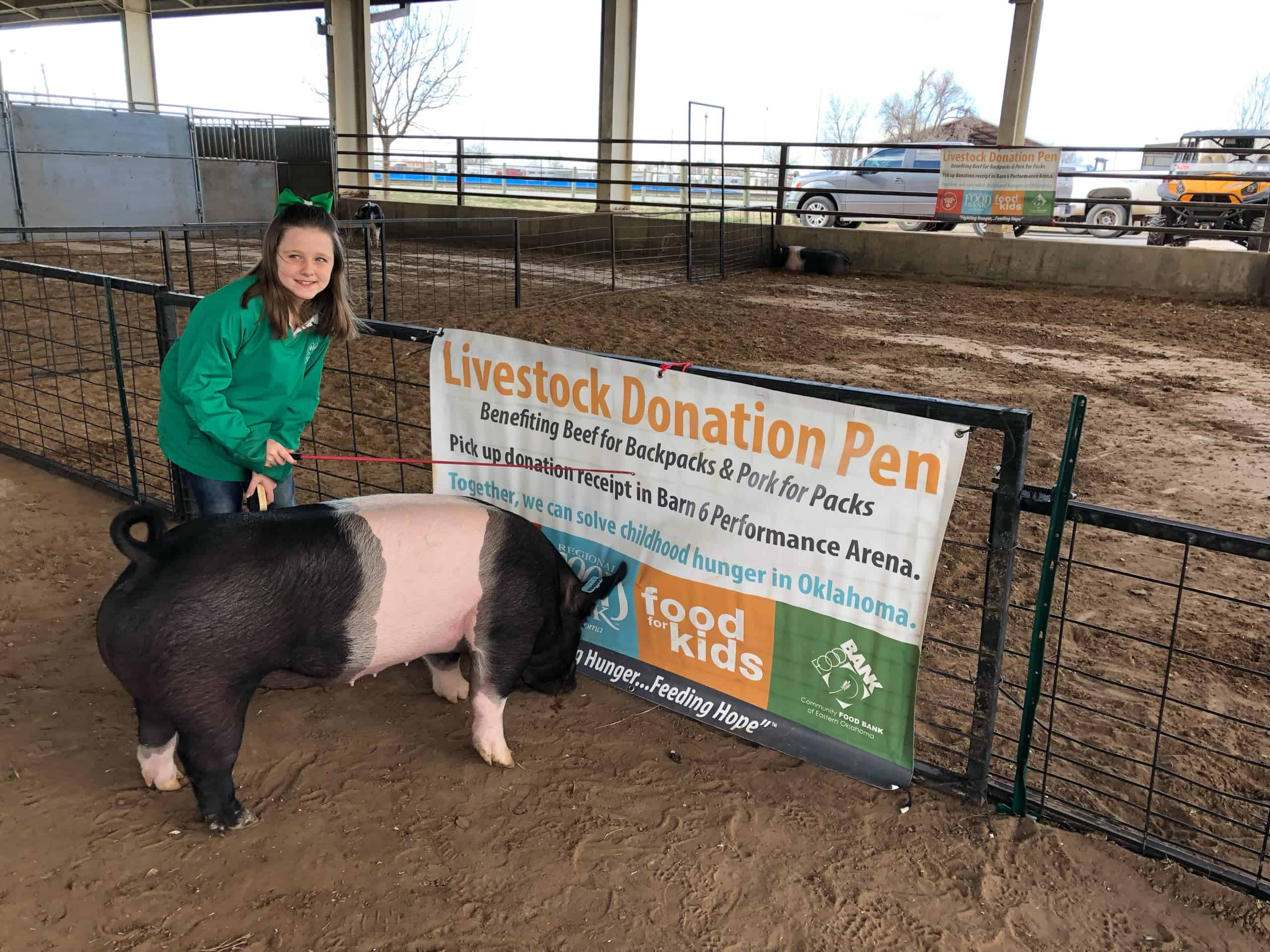 Eight-year-old Maggie Carroll lives to serve as she donates her pig to the Pork for Packs program.