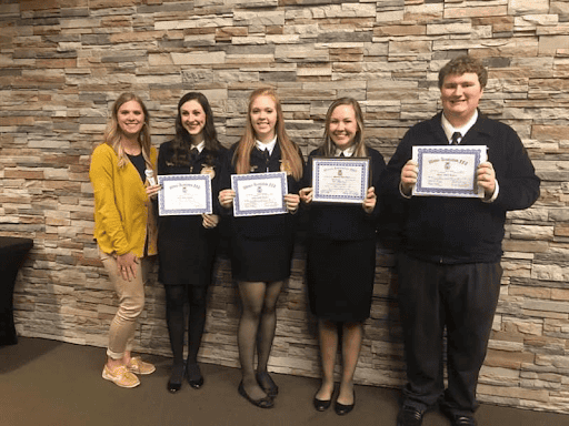 Geisler with some of her students after they got their state degrees.