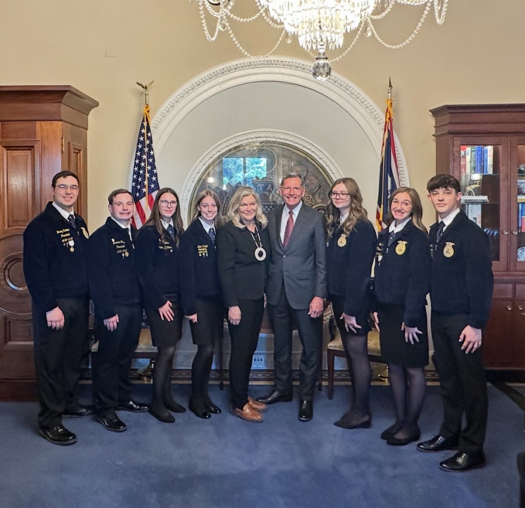 Members stand in the office of the Majority Whip, Senator John Barrasso.