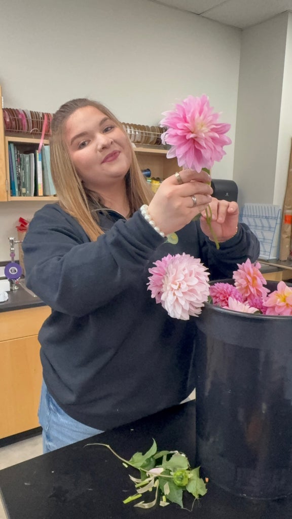 White River FFA member Sofia Gomez preparing flowers to pass out around the school.