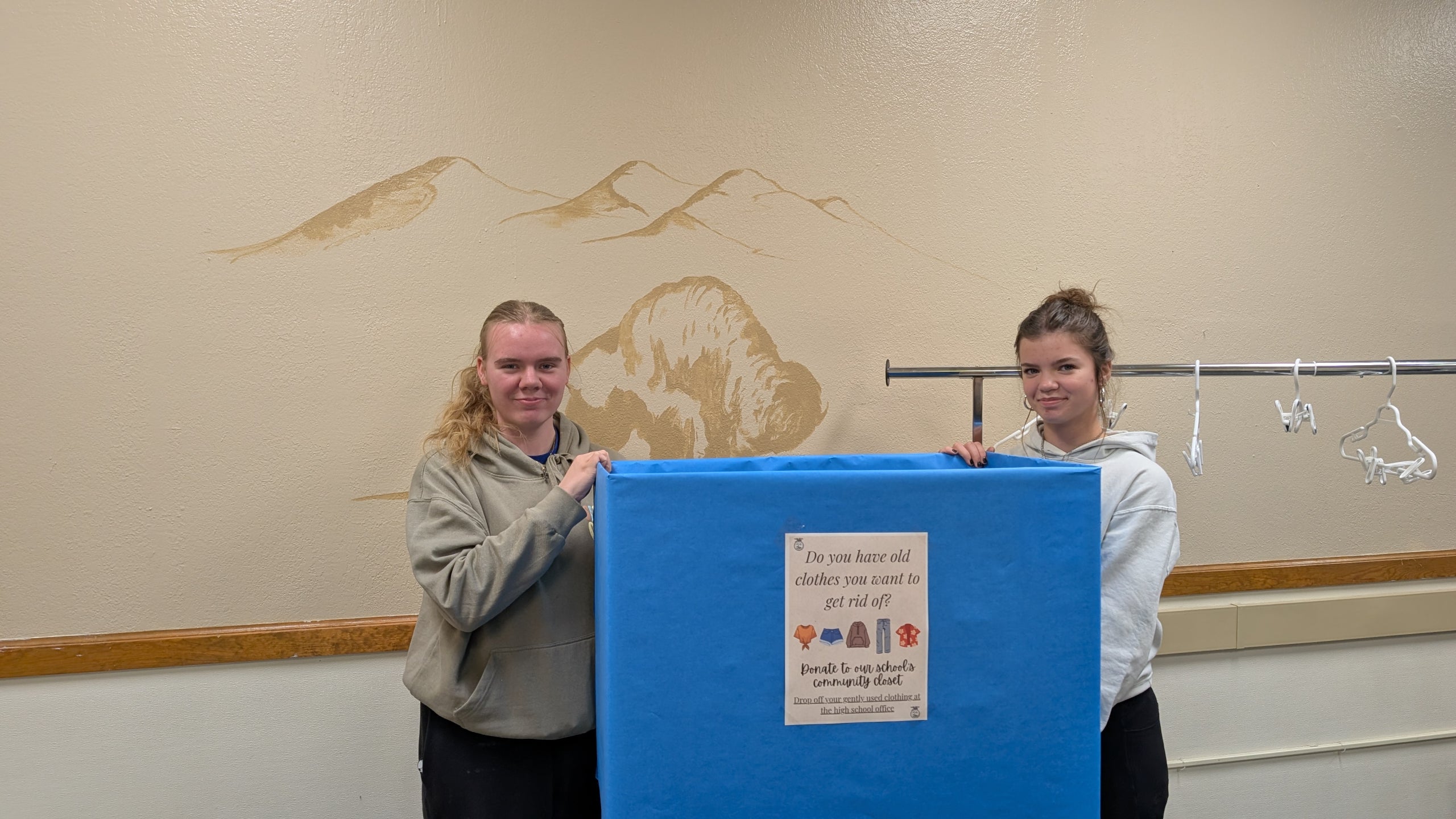 (From left) Lyzzet Rapp and Brynley Erickson show off the donation box inside Hot Springs High School.