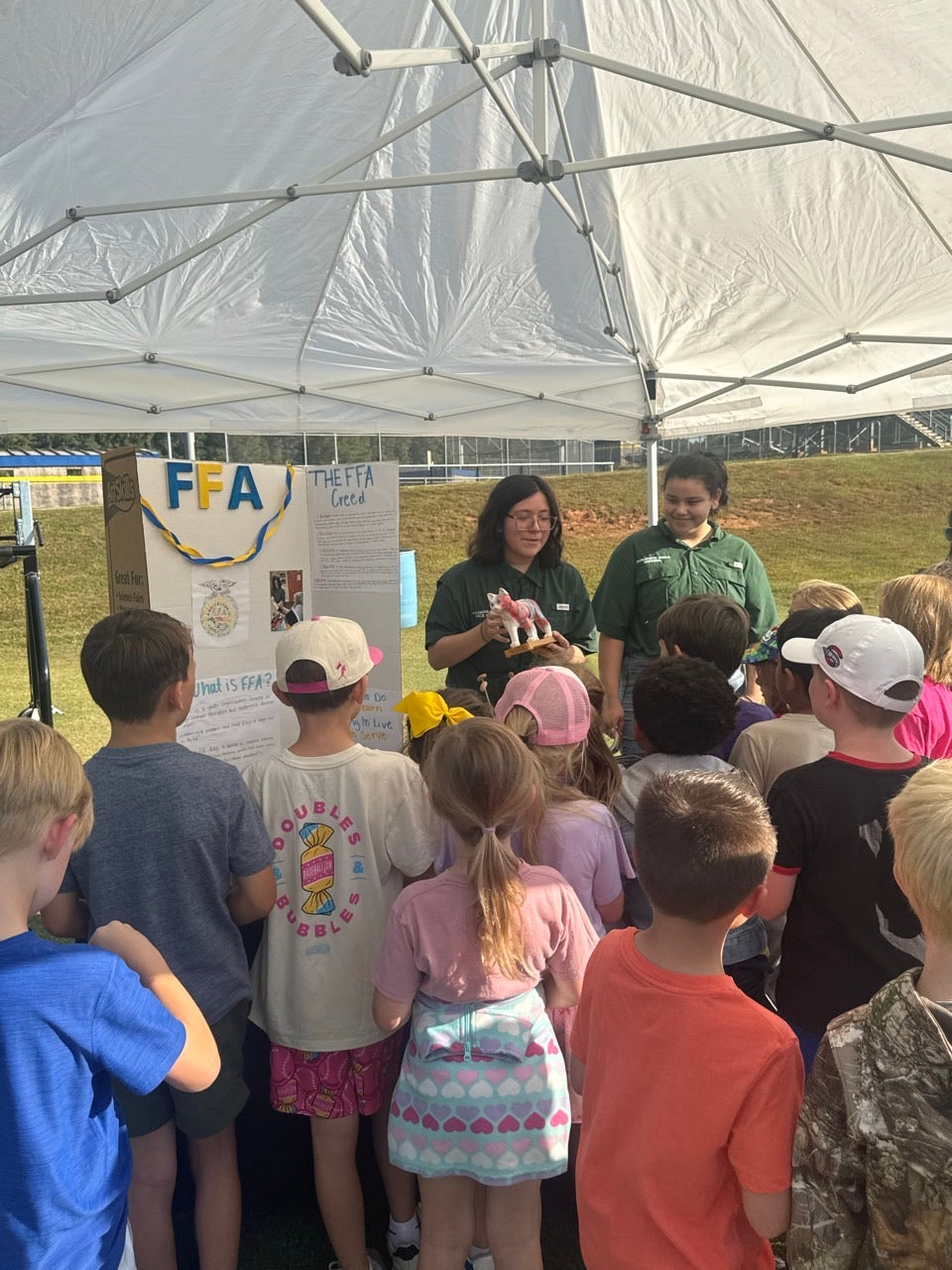 Two Travelers Rest FFA Officers educate second graders about the components of FFA.