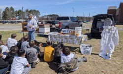 Journeyman Beekeeper, Ted Williamson provides elementary students insight into the world of Bees, at NECP.