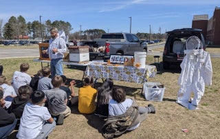 Journeyman Beekeeper, Ted Williamson provides elementary students insight into the world of Bees, at NECP.