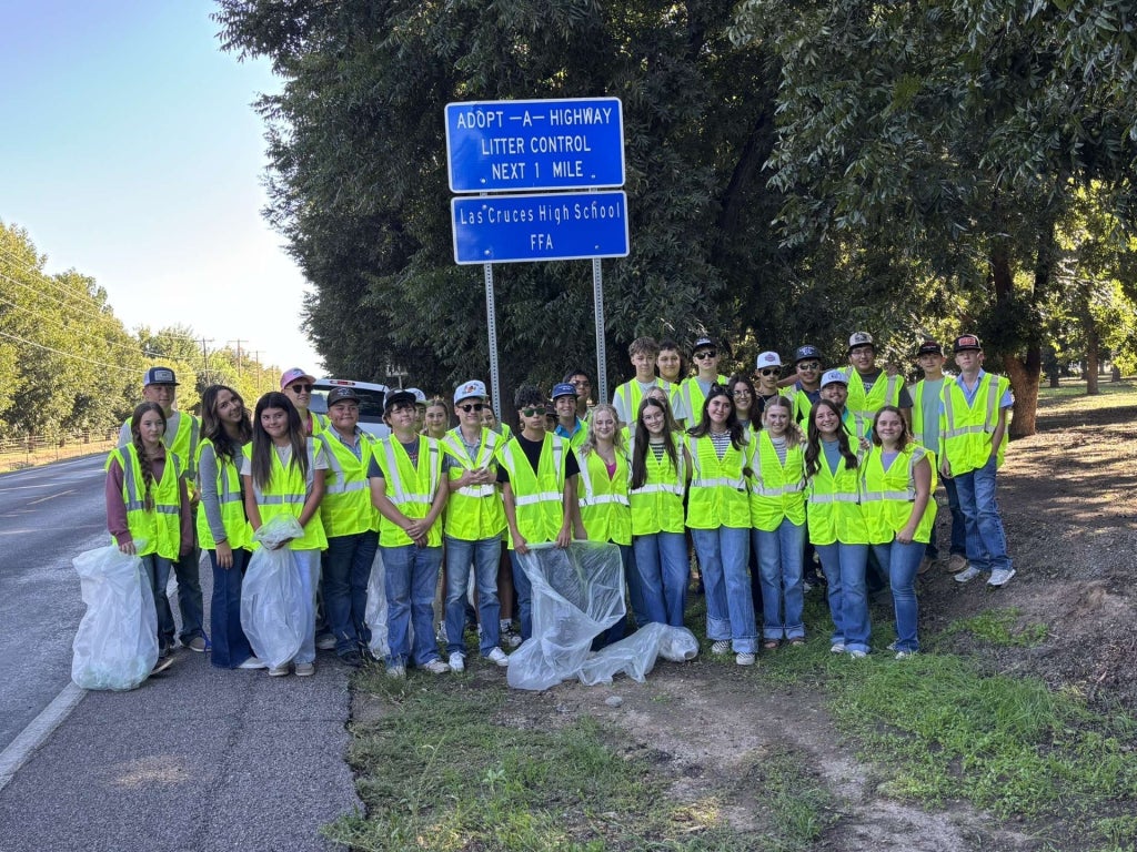Las Cruces FFA members pose with their cleaned highway.