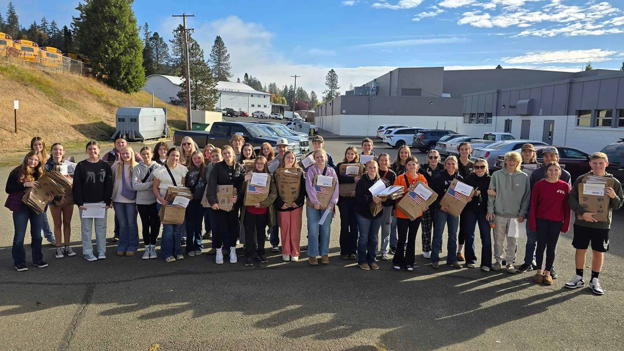 Sutherlin FFA members hold the food drive bags.