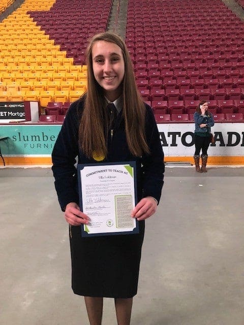 Feldman receives her “Dedication to Teach Agriculture” certificate.