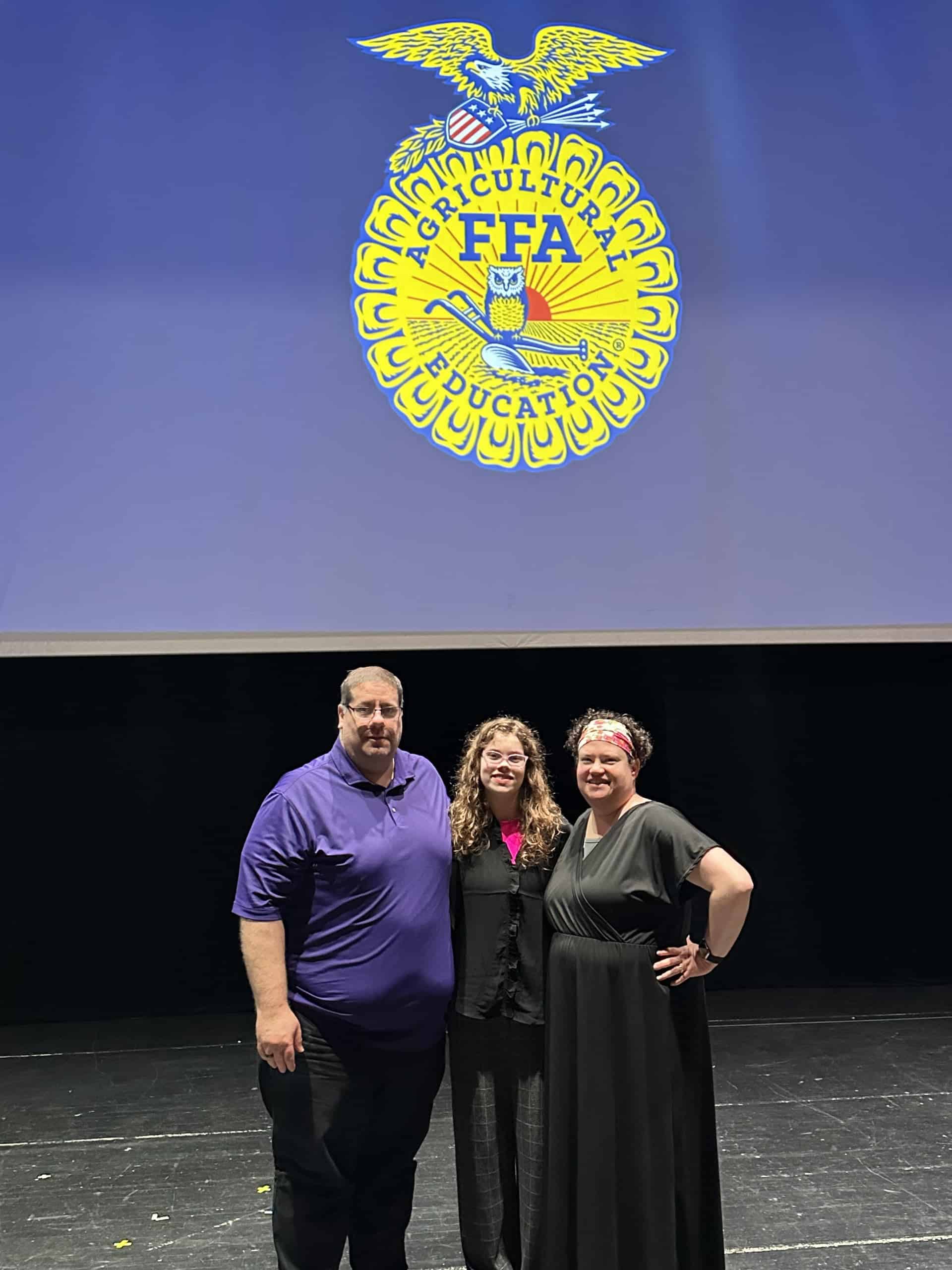 Alexander stands proudly with her husband, Bill, and daughter, Bridget, at state convention.