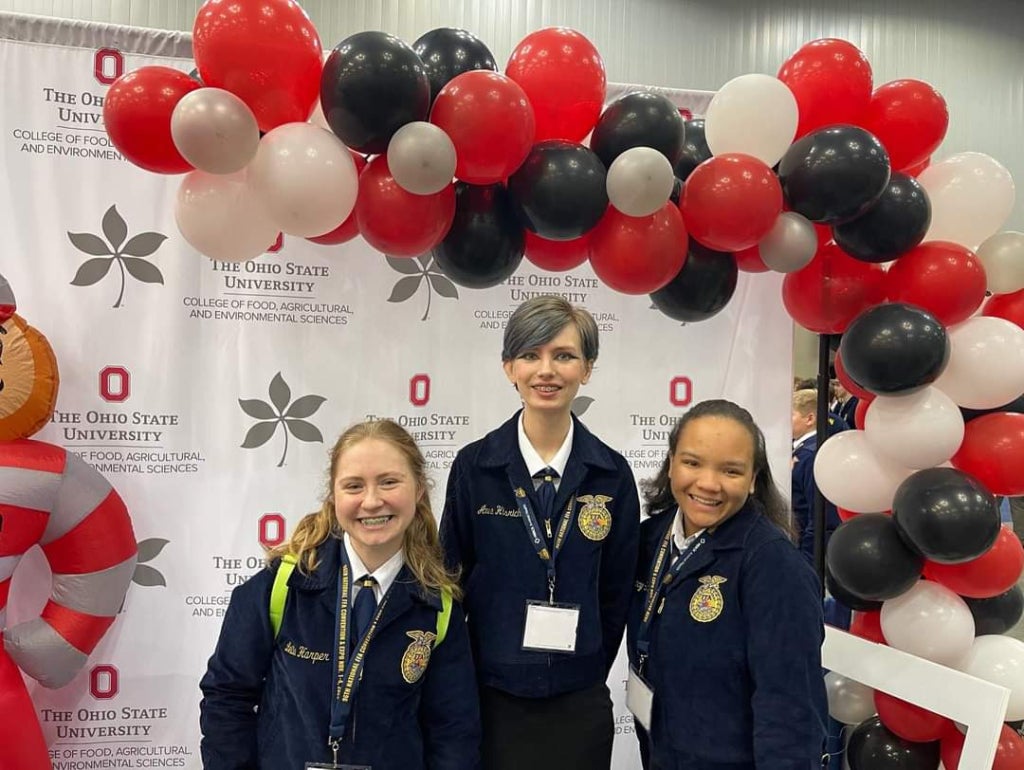 2023-24 Bio-Med Science Academy FFA Officers Leila Harper, Anna Hisrich and Gracy Smith pose for a picture at the Ohio State University booth while at the 96th National FFA Convention & Expo.