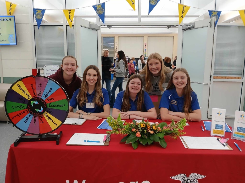 Chapter officers wait to check interested students into the open house!