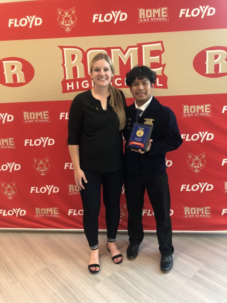 Left side- Mrs. Dunaway. Right side Former alumni Esdras Paiz taking a picture with his FFA plaque.