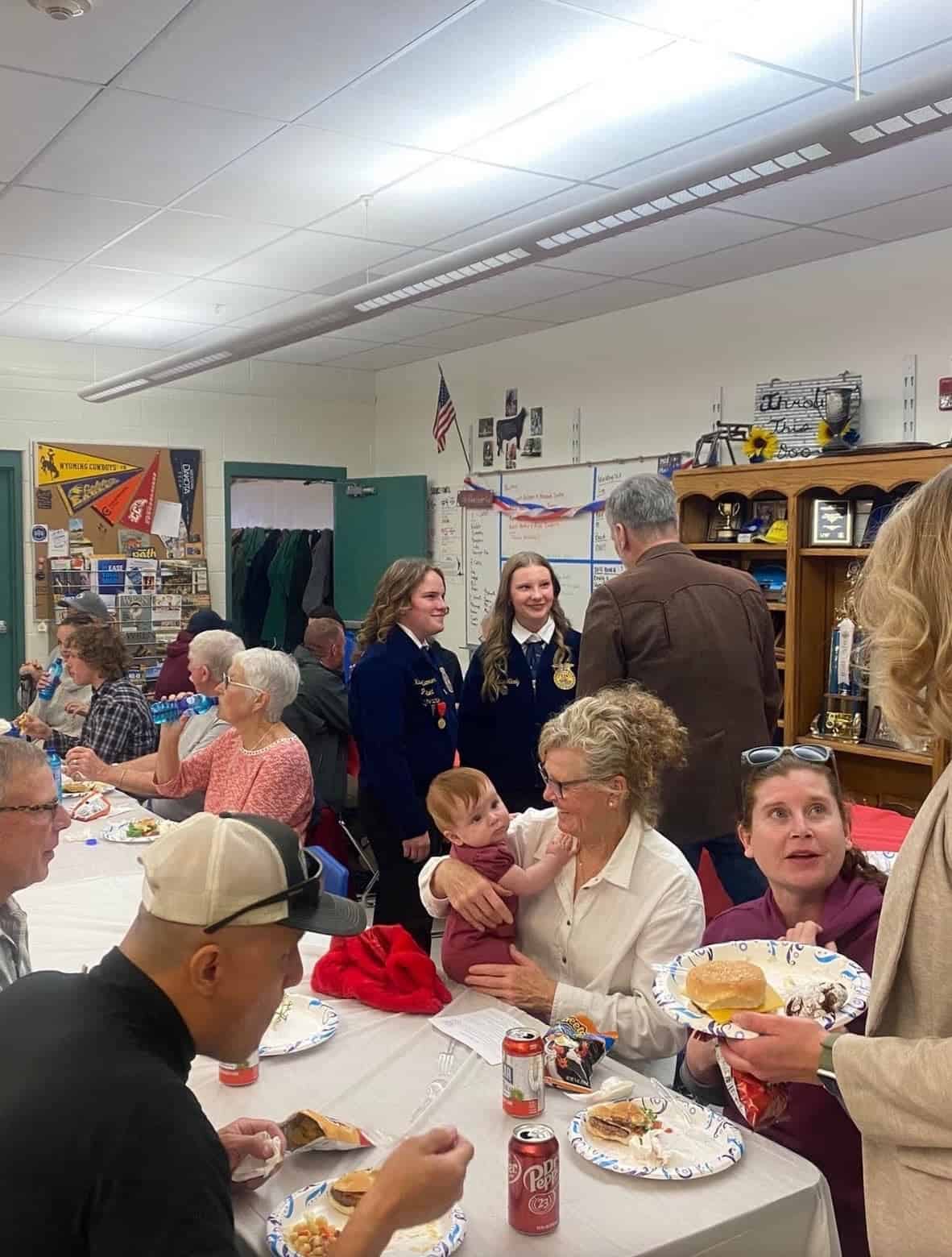 Kadence Kummer (Left, 2024-2025 Lander FFA President) and Madalyn Nicely (Right, 2025-2026 Lander FFA President) talk with veterans at the 2024 Veterans Day BBQ.