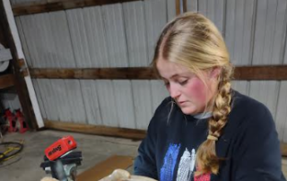 Henning skinning her animal to prepare for mounting