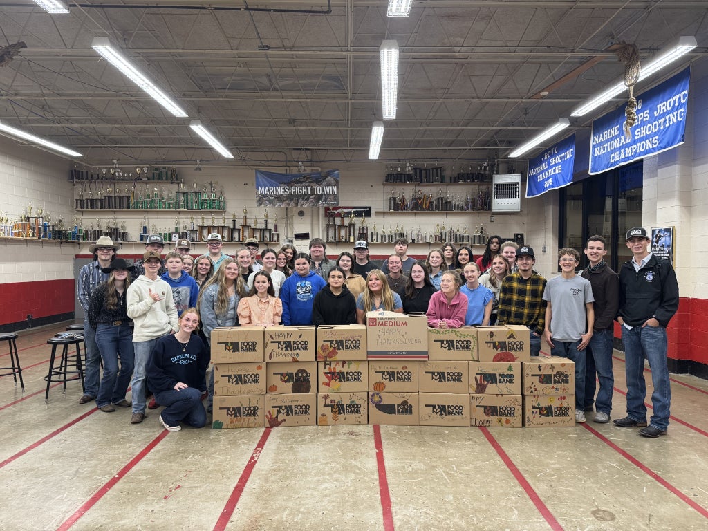 Sapulpa FFA members gather around completed Thanksgiving boxes.