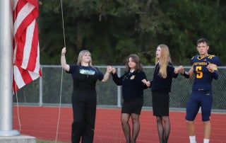 FFA officers representing many organizations raise the flah