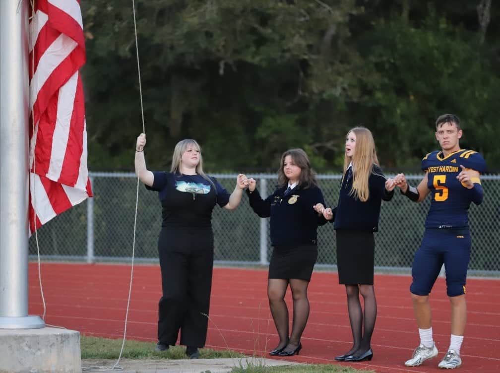 FFA officers representing many organizations raise the flah