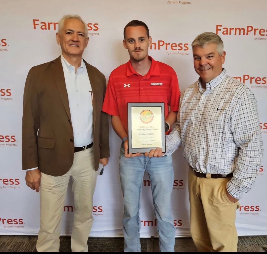 Atkins with his dad and Brent Murphy, the Delta Farm Press delta region writer this year, after they won the 2025 Peanut Efficiency Award in the delta region.