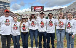 Virginia FFA State Officers Danika Landreth, Kylie Bailey, Emma Alexander, Lee Kent, Franco Abud, Georgia Grady, and Alli Phillips along with Mr. Andy Seibel wearing their FFA Game Day shirts.