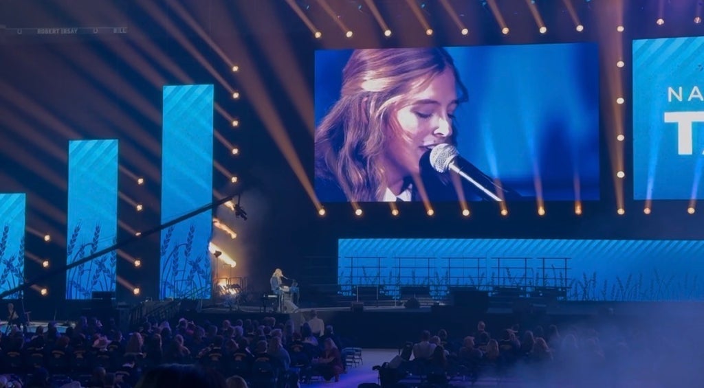 Schrage performs on stage in Lucas Oil Stadium.