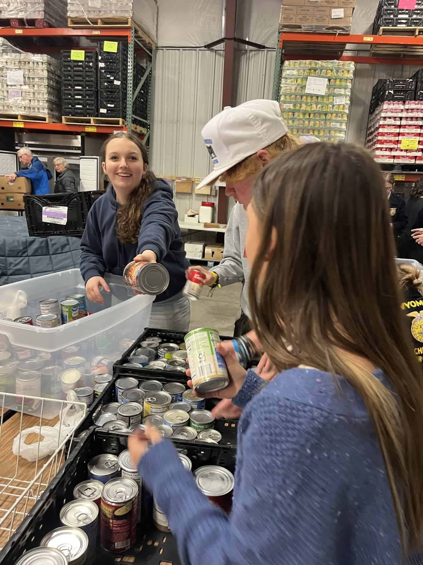 Members organize food items at the St. Joseph’s Food Pantry.