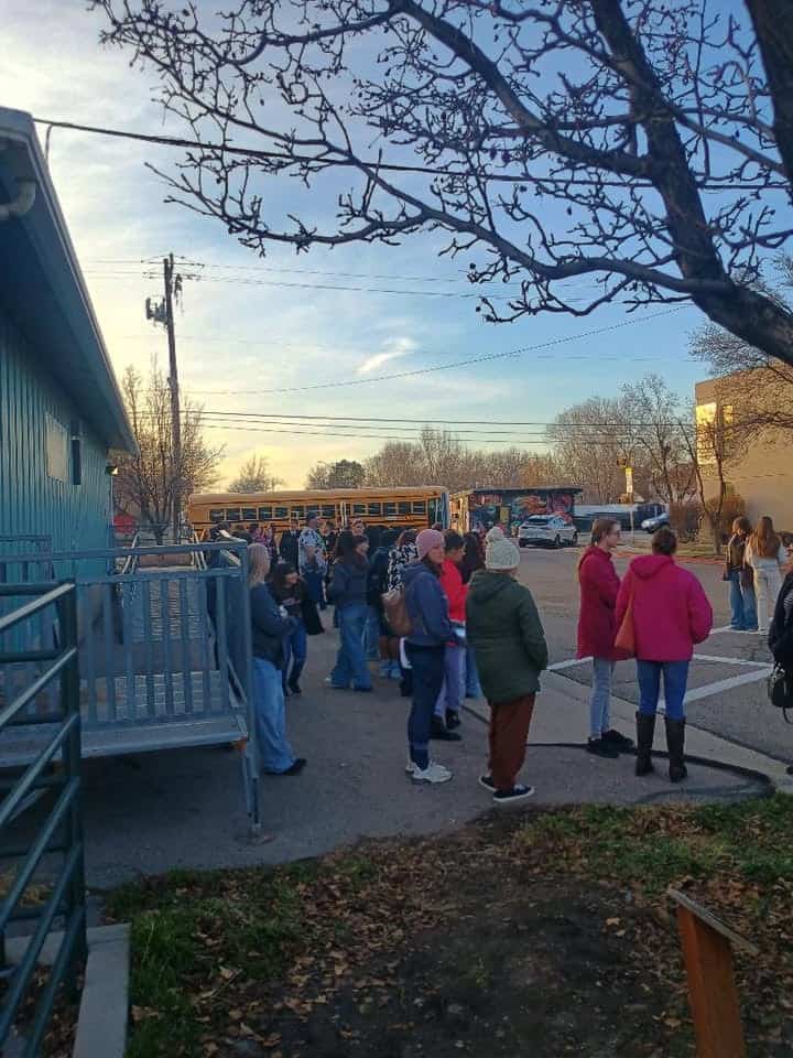 Students and parents standing outside of the agriculture relocatable.