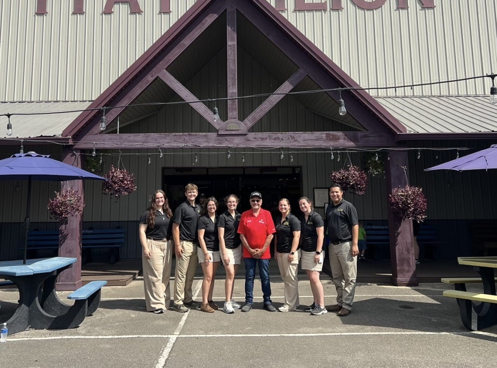 The Indiana FFA State Officer Team with Featured Farmer Dave Schrock.