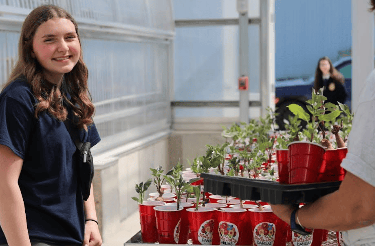 Mose smiles as she sells her plants.