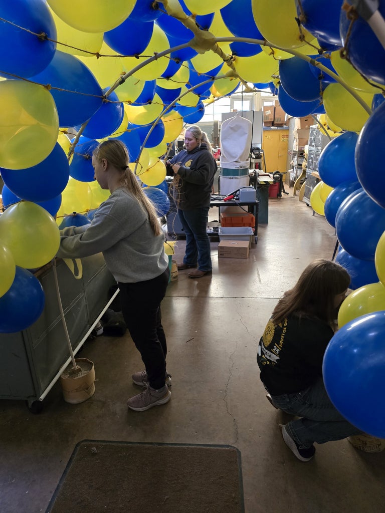 Chapter officers decorate the entrance by creating their own balloon arch.