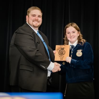 Johns and Brynna Raines celebrate her accomplishments. 