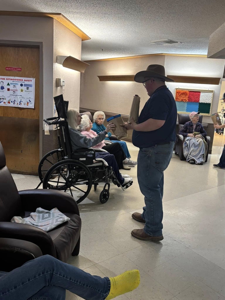 Garrett Stark hands out a gift bag to a resident.