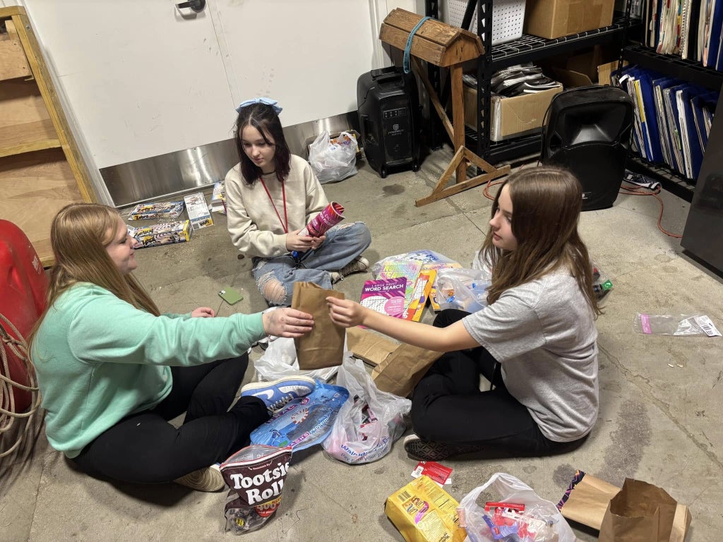 Taryn Dunivan (left), Ryleigh Wilson (middle) and Kaitlyn Houghton (right) assemble gift bags for seniors.