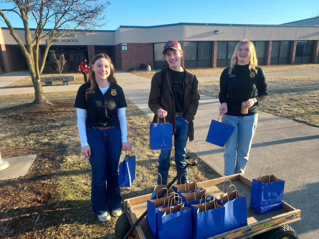 Members of the Broadway FFA Chapter hand out appreciation bags.