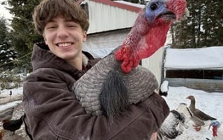 Ethan Cowell and one of his turkeys.