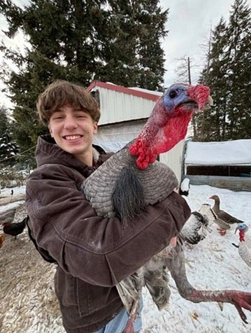 Ethan Cowell and one of his turkeys.