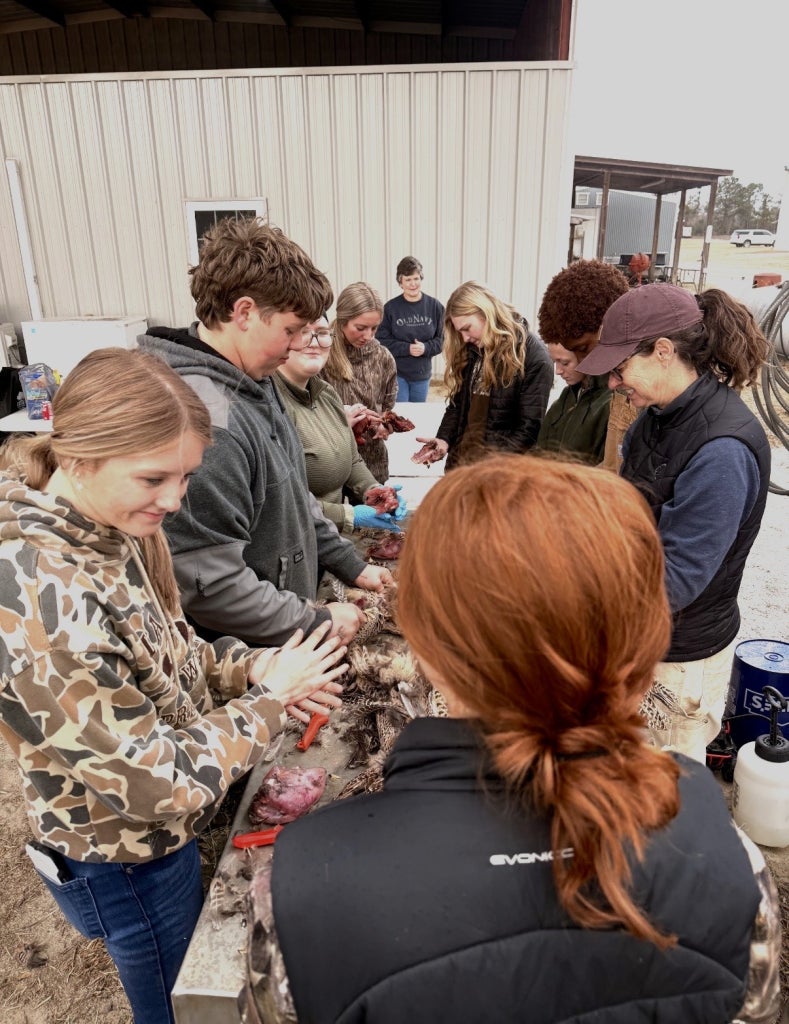The Screven County High School FFA Chapter cleans birds for the hunters to take home.